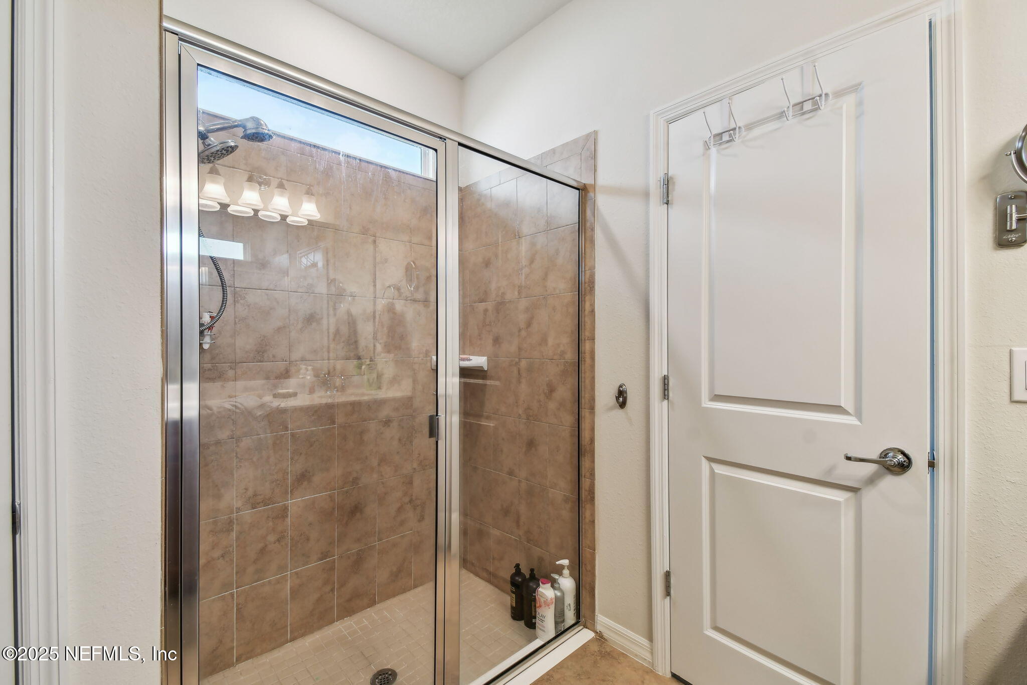 182 Myrtle Oak Court St. Augustine, FL 32092 - Photo 27 of 81 a bathroom with a glass shower door and a window