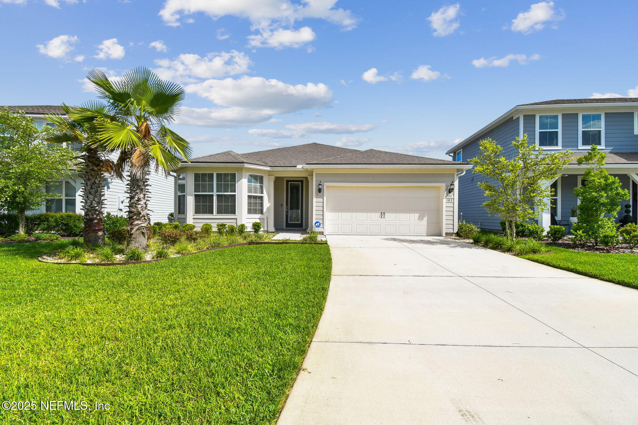 182 Myrtle Oak Court St. Augustine, FL 32092 - Photo 4 of 81 a front view of a house with a garden and plants