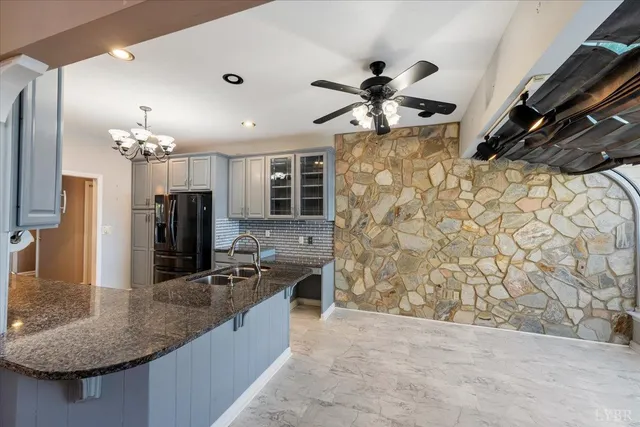 a kitchen with stainless steel appliances granite countertop a sink a counter top space cabinets and stainless steel appliances