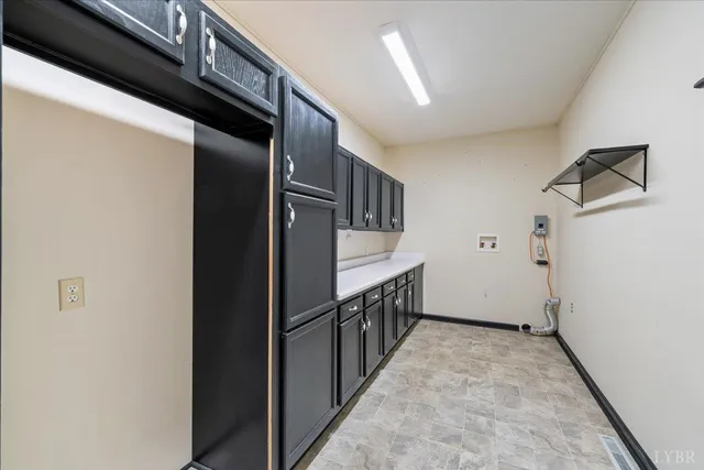 a view of an empty room with a window and a kitchen