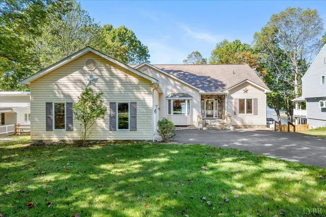 a view of a house with a yard and sitting area