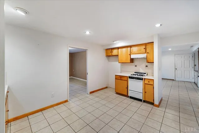 a view of an empty room with a fireplace and a window