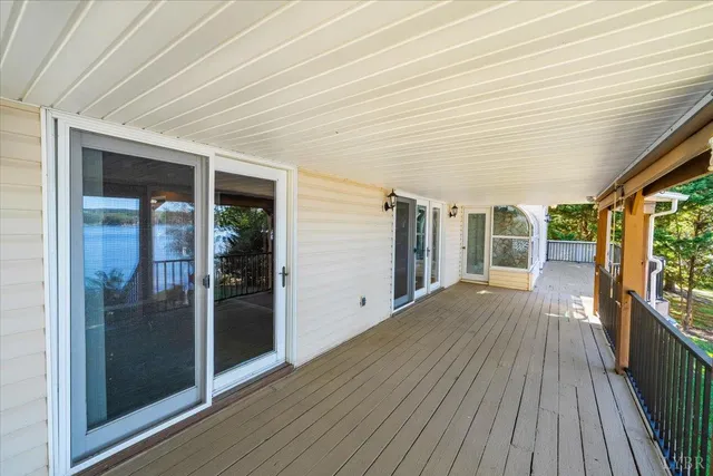 a aerial view of a house with swimming pool patio and lake view
