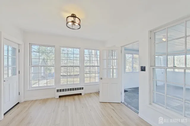 a view of a kitchen with wooden floor and a sink
