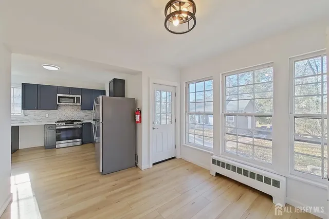 a view of kitchen with furniture and wooden floor