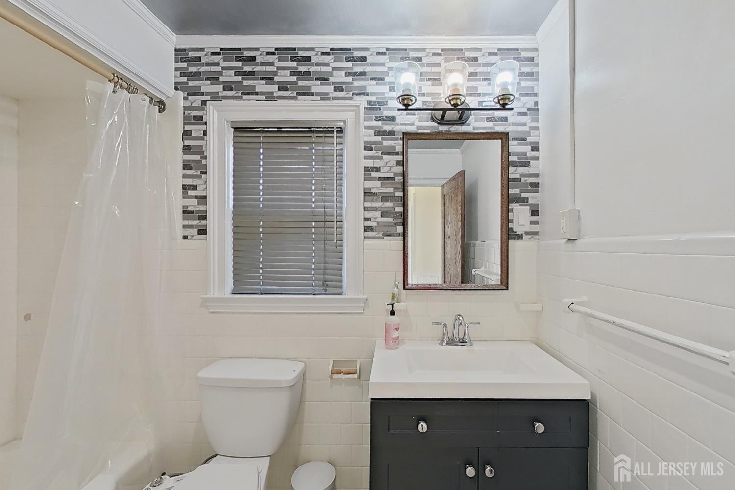 205 Ashland Road Middlesex, NJ 08846 - Photo 25 of 48 a bathroom with a granite countertop sink a toilet and a mirror