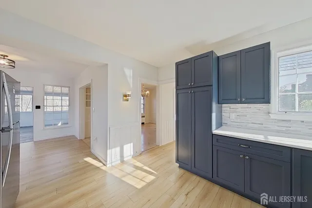 a view of a kitchen with wooden floor and a sink