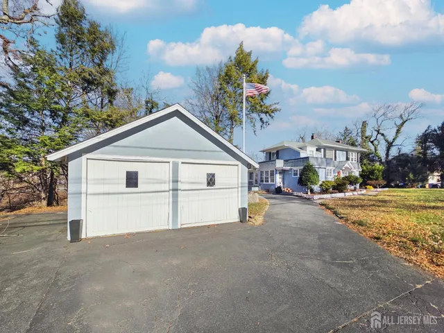 a view of a house with a yard and garage