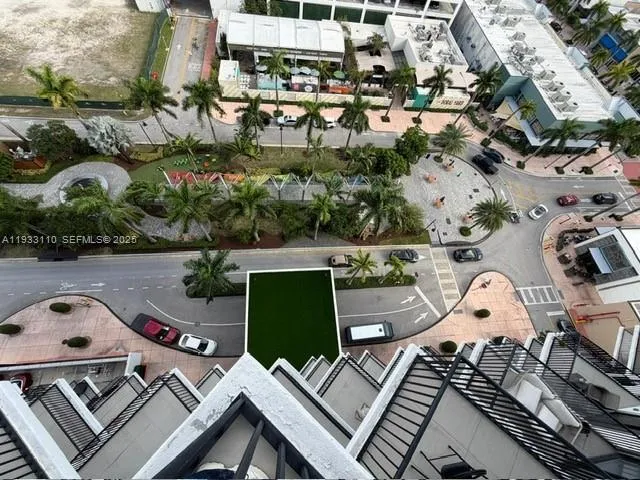 a view of a balcony with two chairs and a stove