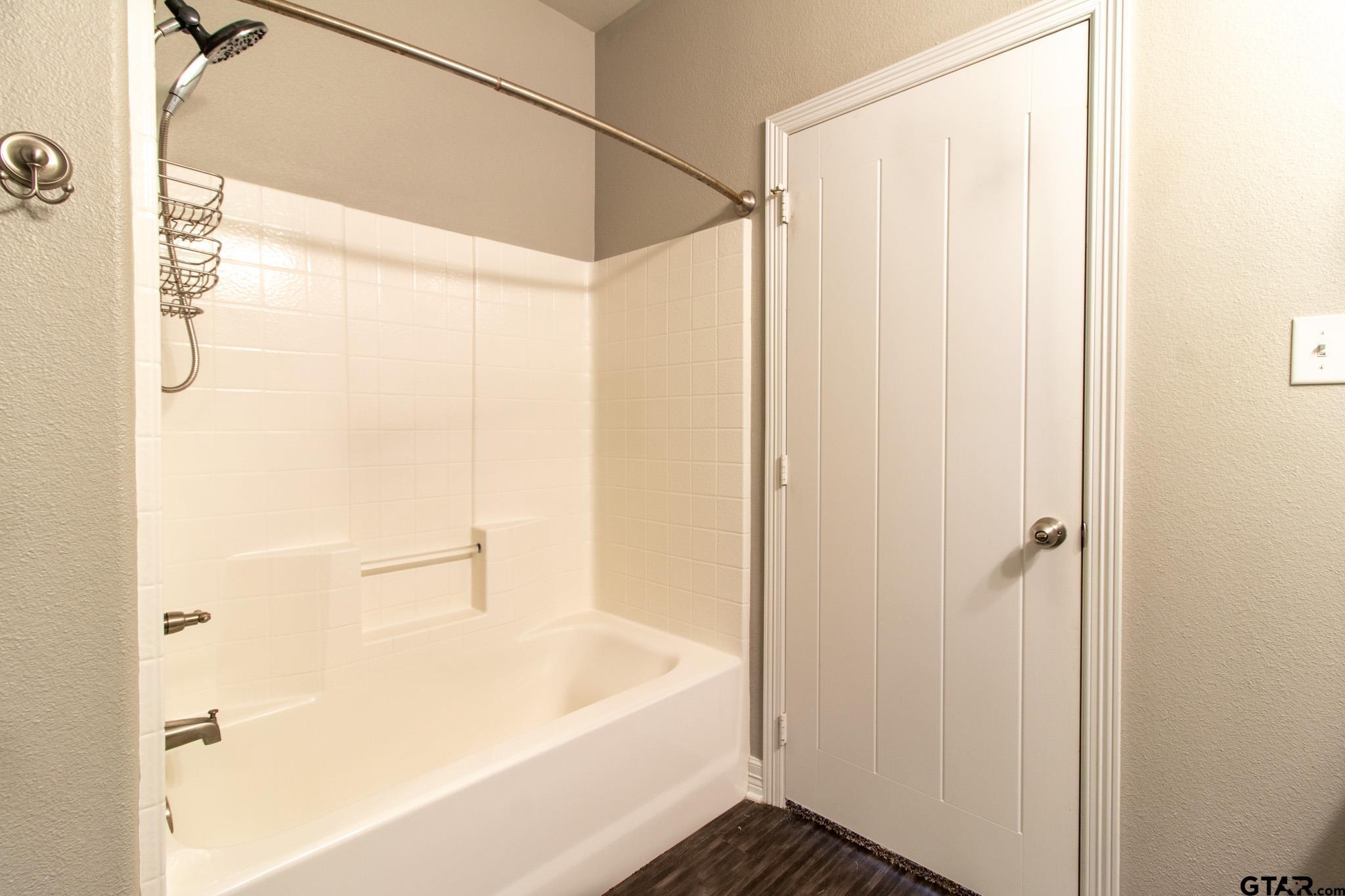 2806 Valley View Street Tyler, TX 75701 - Photo 13 of 22 a bathroom with a bathtub and a shower