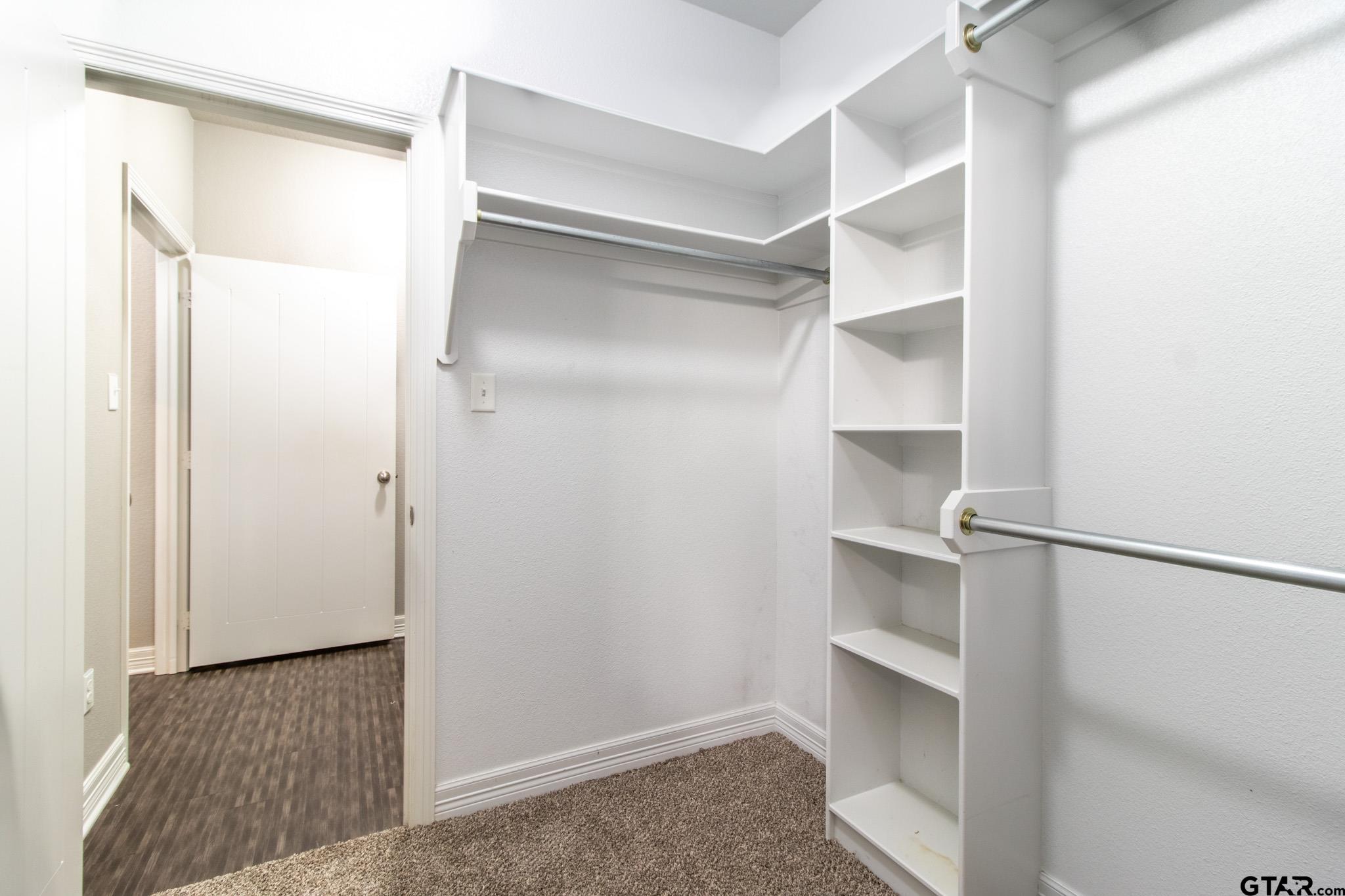 2806 Valley View Street Tyler, TX 75701 - Photo 14 of 22 a view of walk in closet with empty racks