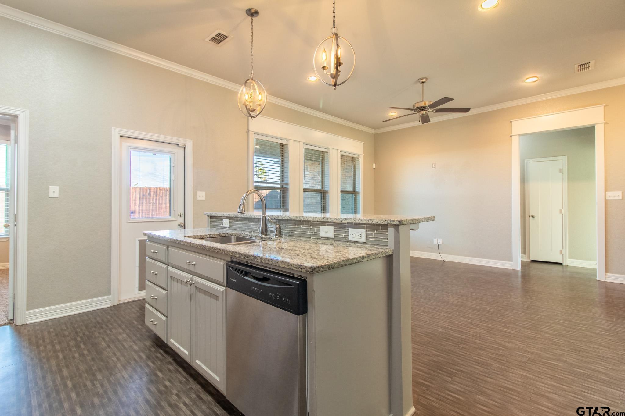 2806 Valley View Street Tyler, TX 75701 - Photo 17 of 22 a kitchen with stainless steel appliances granite countertop a sink and wooden floor