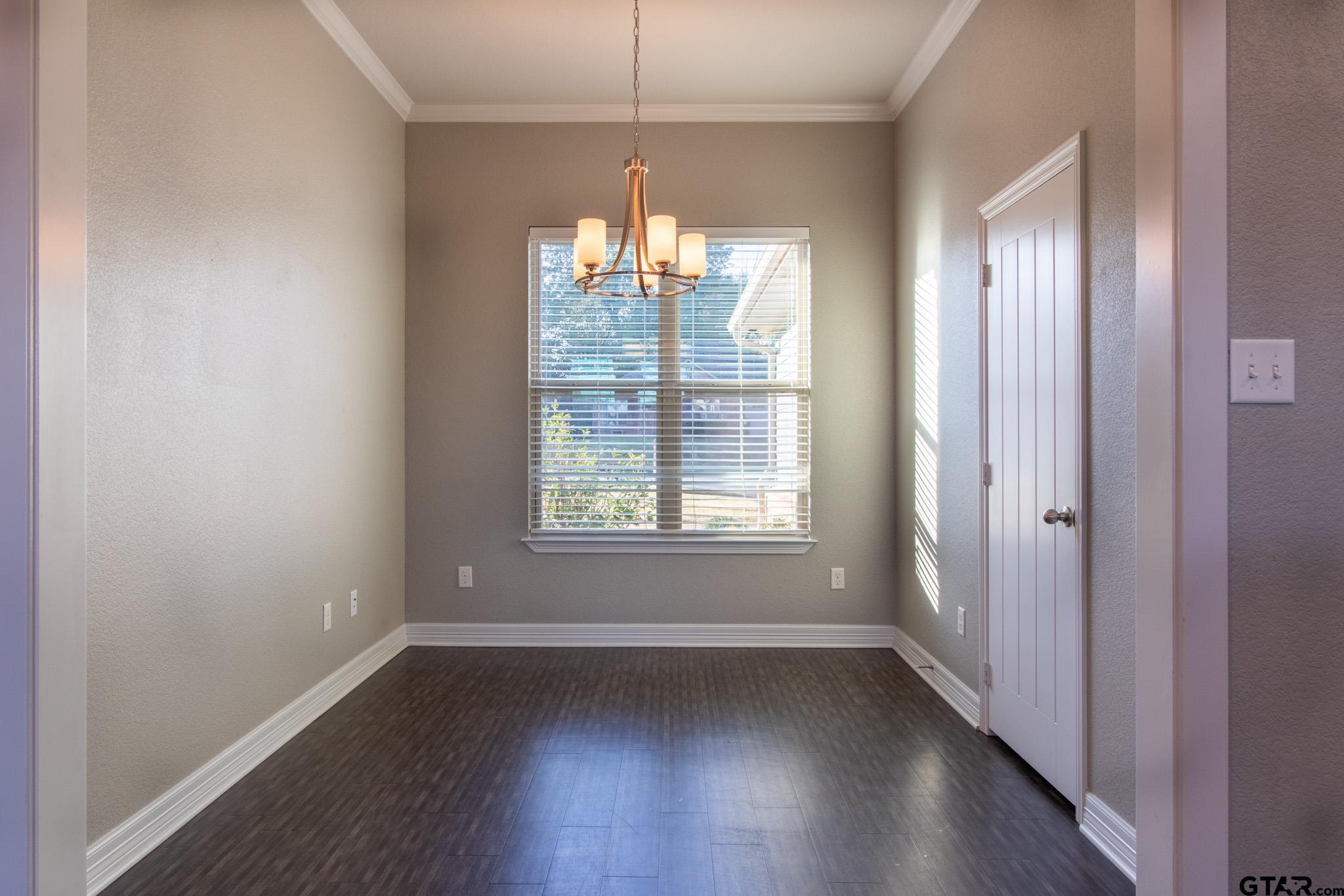 2806 Valley View Street Tyler, TX 75701 - Photo 6 of 22 a view of an empty room with wooden floor and a window
