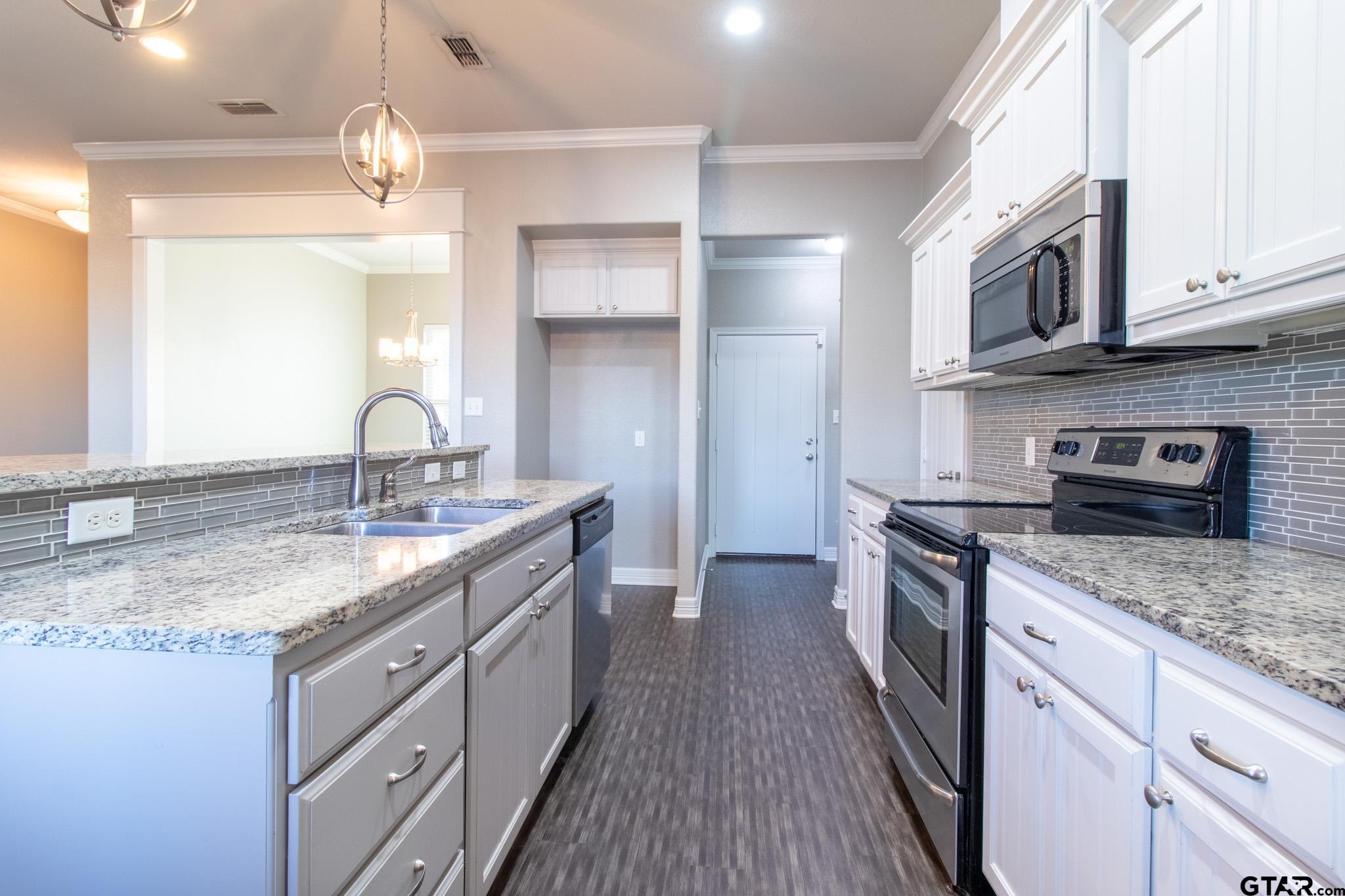 2806 Valley View Street Tyler, TX 75701 - Photo 9 of 22 a kitchen with stainless steel appliances granite countertop a sink stove and refrigerator