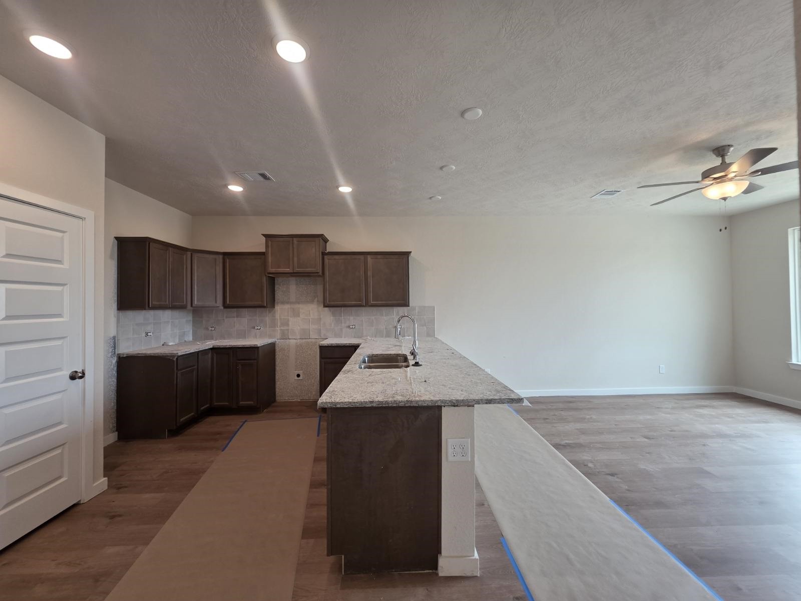 1498 Lk Rdg Drive Brenham, TX 77833 - Photo 4 of 14 a kitchen with a refrigerator and a sink