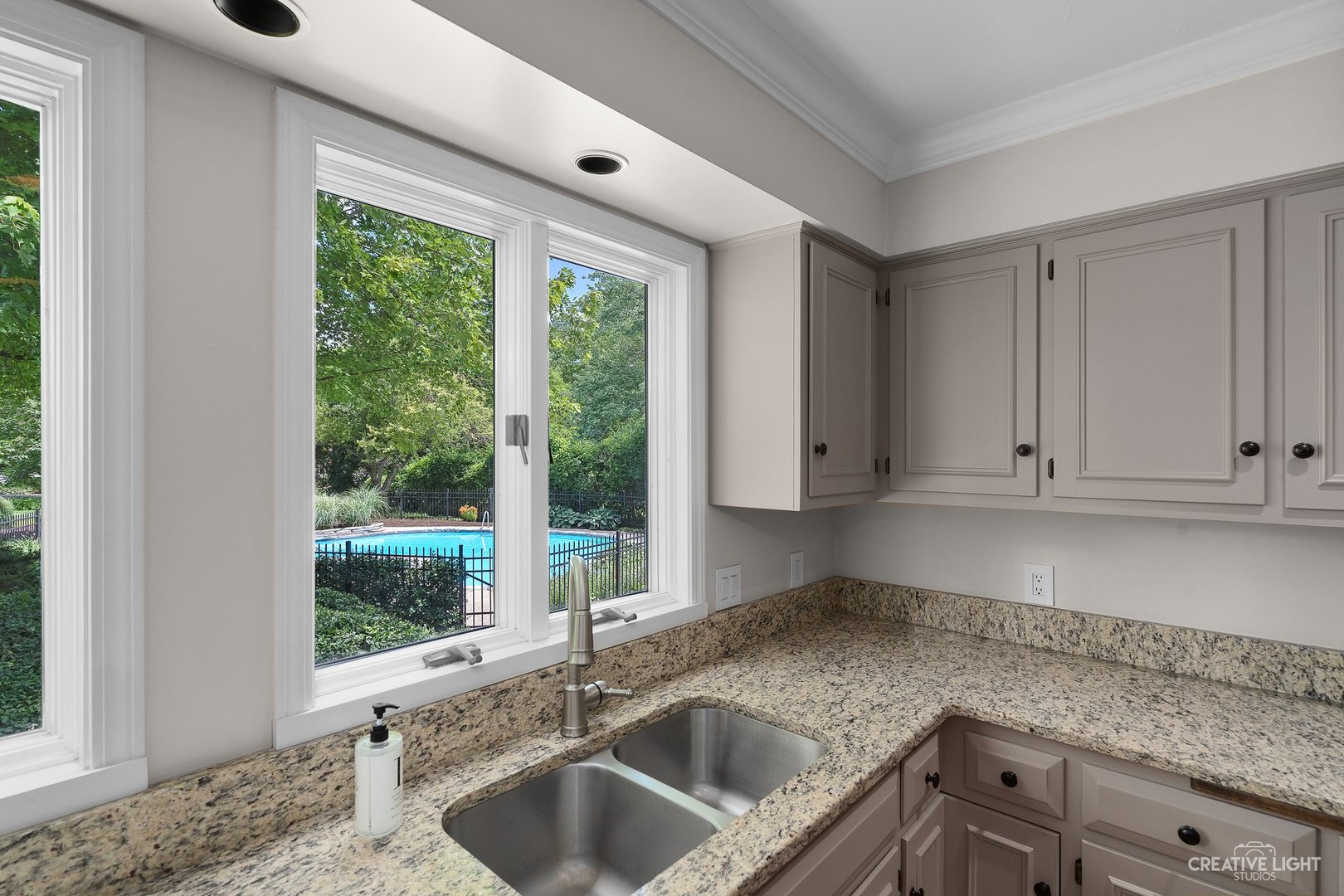 10 Aintree Road St. Charles, IL 60174 - Photo 13 of 34 a kitchen with granite countertop a sink and a window