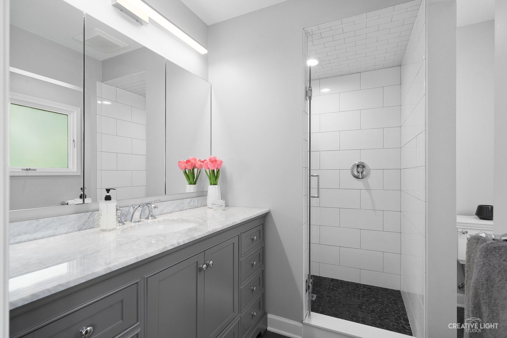 10 Aintree Road St. Charles, IL 60174 - Photo 15 of 34 a bathroom with a shower sink and mirror