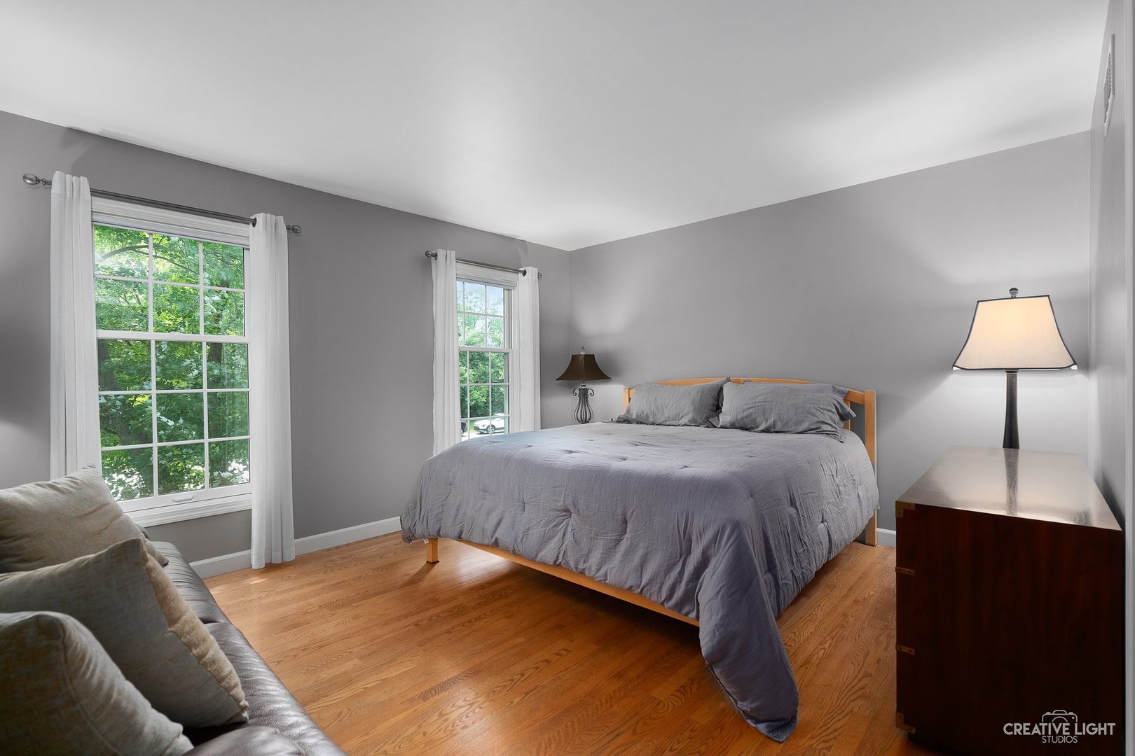 10 Aintree Road St. Charles, IL 60174 - Photo 17 of 34 a bedroom with a bed and lamp next to a window