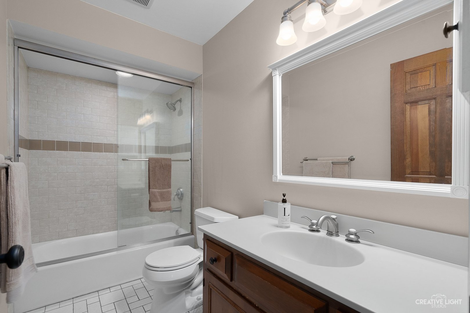 10 Aintree Road St. Charles, IL 60174 - Photo 20 of 34 a bathroom with a sink a toilet and shower