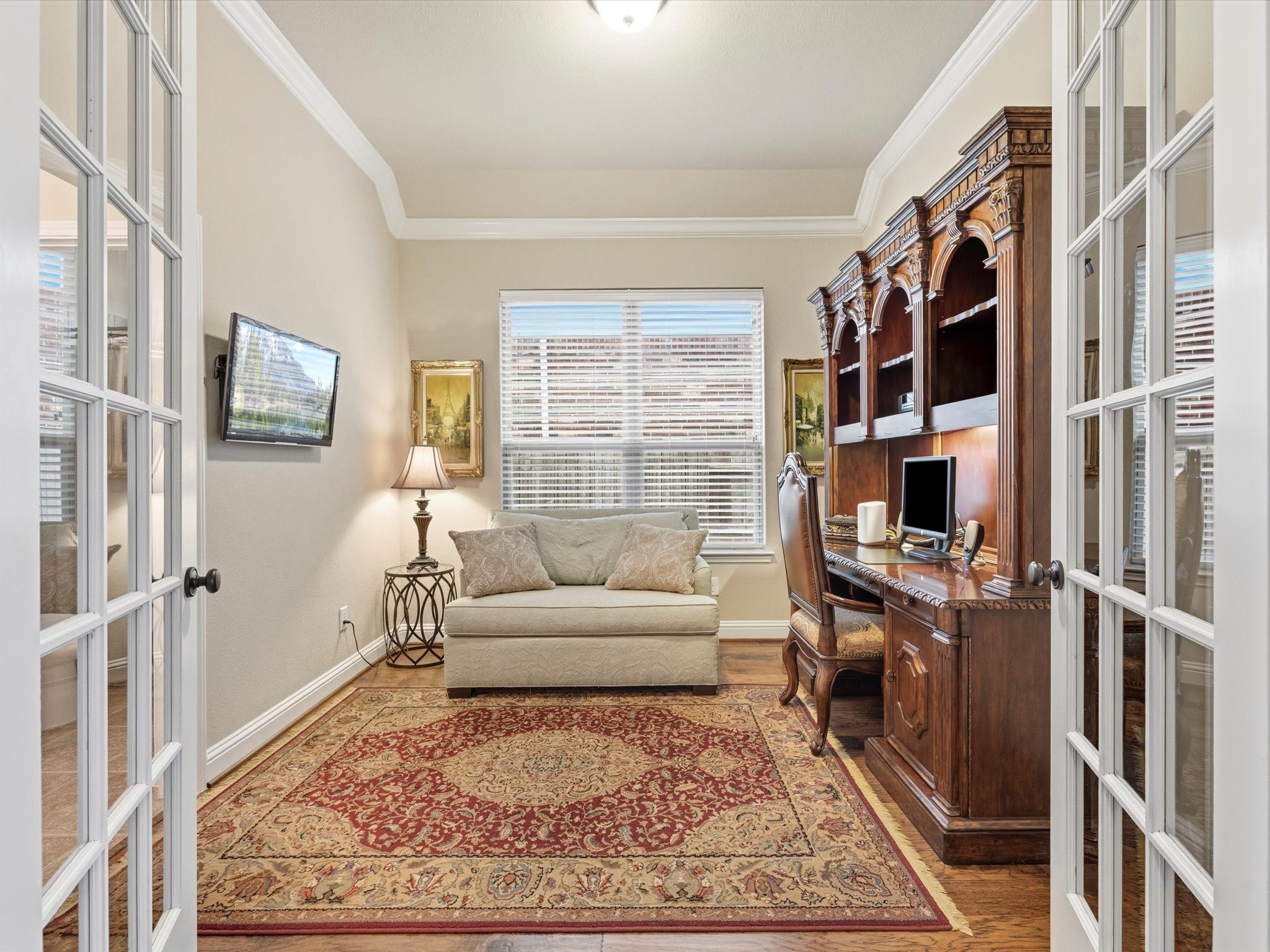 3907 Randle Ridge Court Fulshear, TX 77441 - Photo 6 of 46 This photo showcases a home office with French doors with connection to a full bathroom and has a closet. It features a large window for natural light.