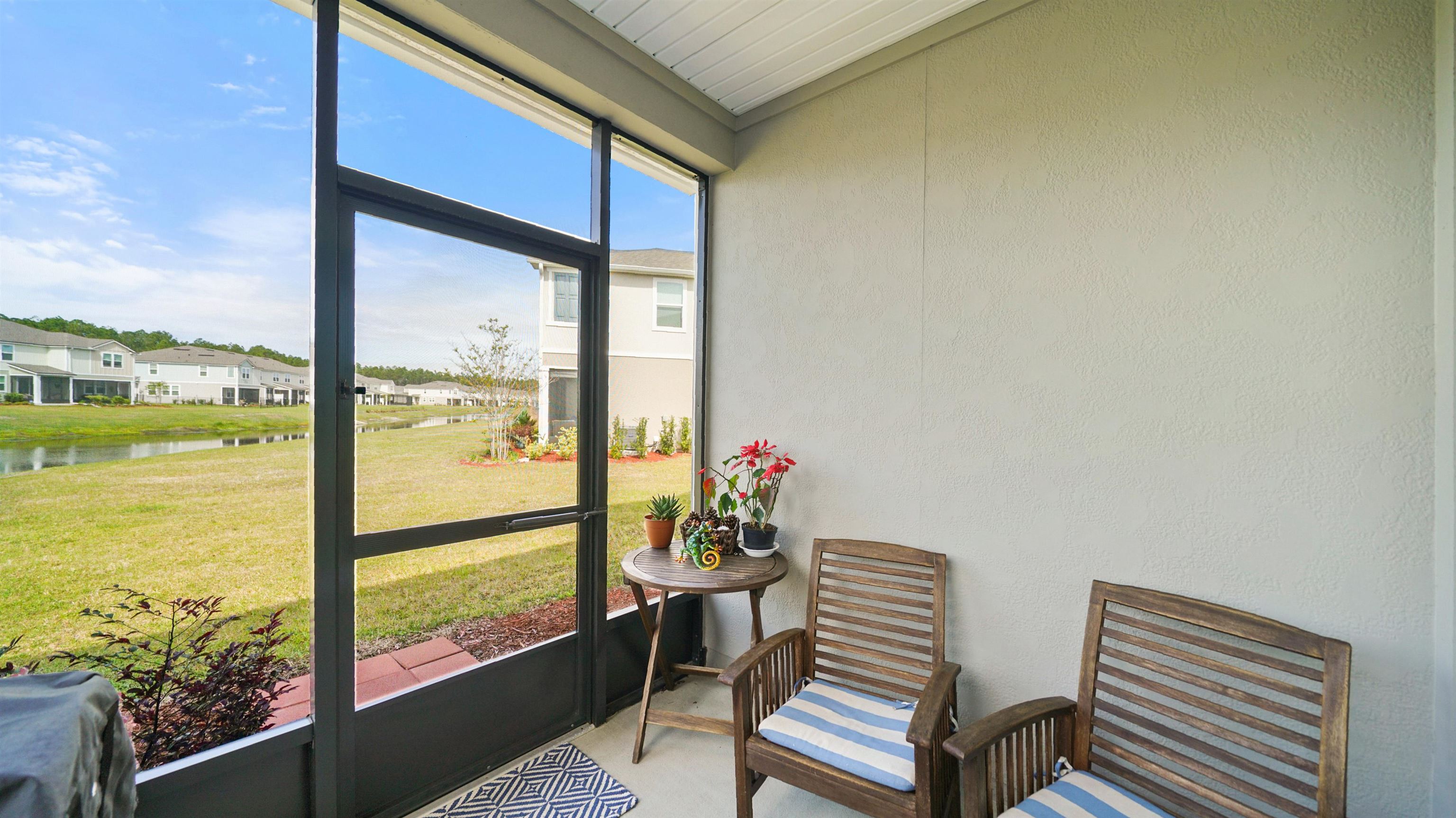 194 Redbud Road Palm Coast, FL 32137 - Photo 13 of 34 a view of a room with a large window and floor to ceiling window next to a yard