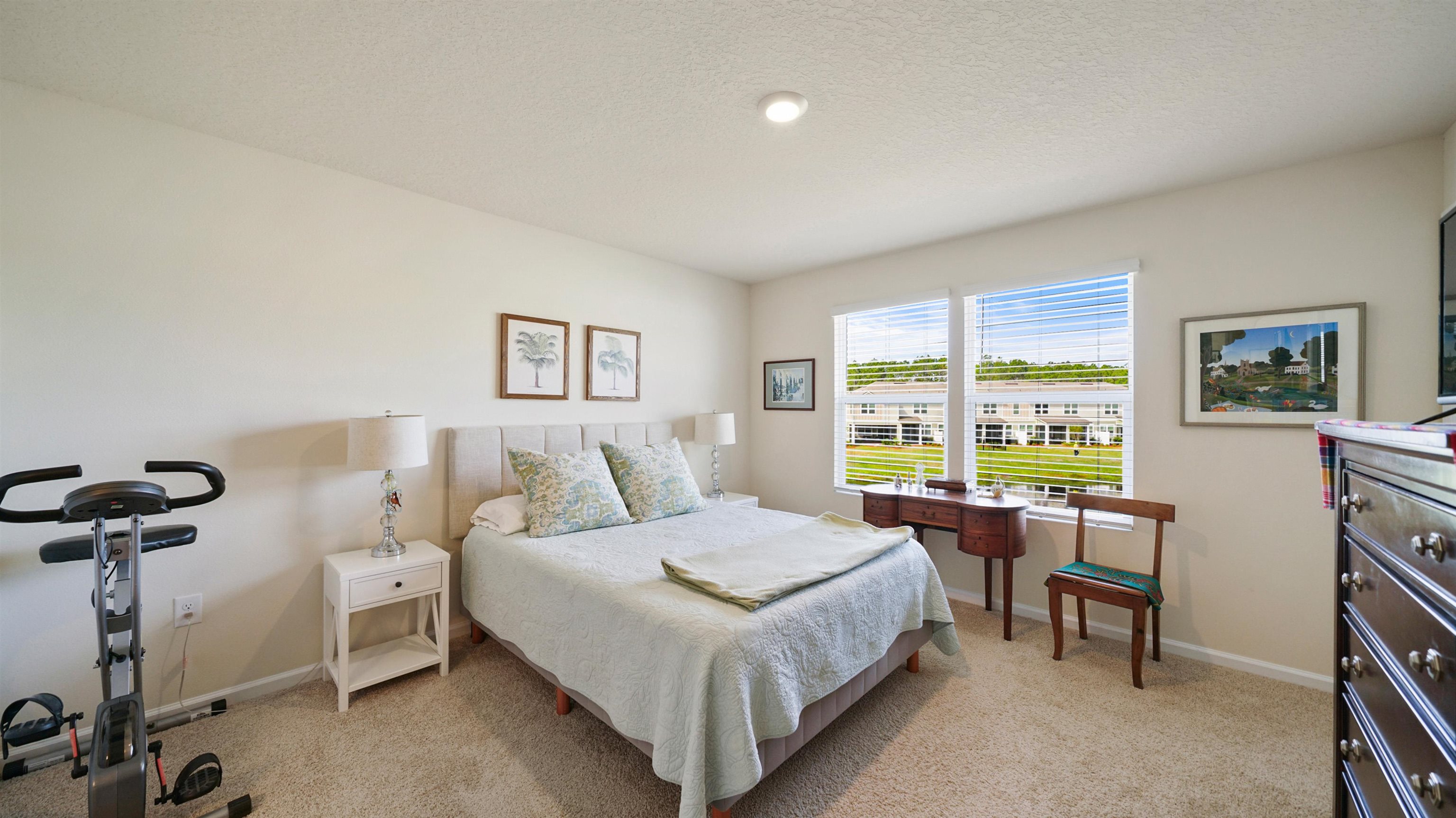 194 Redbud Road Palm Coast, FL 32137 - Photo 14 of 34 a bedroom with a bed and a large window