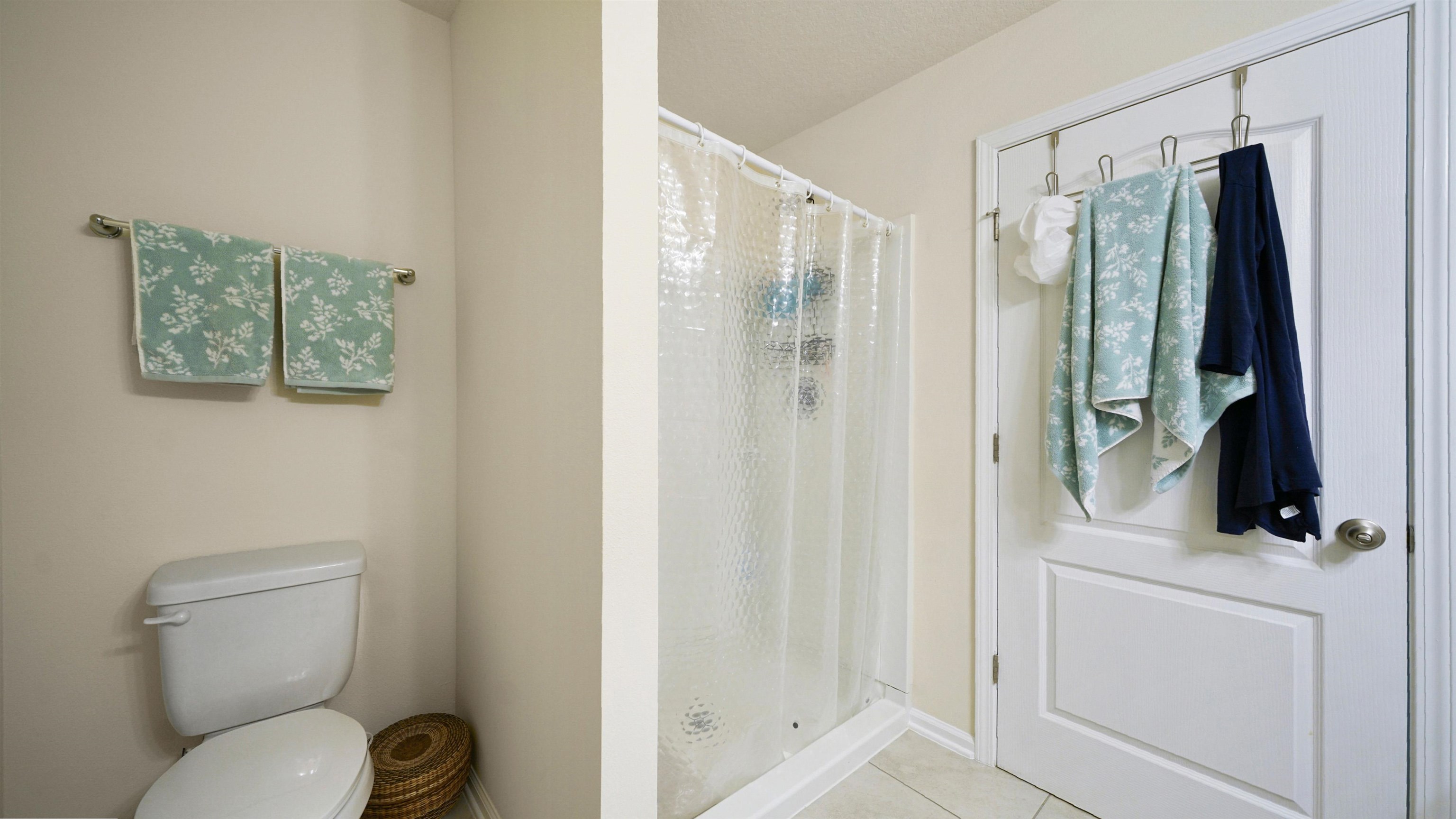 194 Redbud Road Palm Coast, FL 32137 - Photo 17 of 34 a bathroom with a shower a toilet a sink and mirror