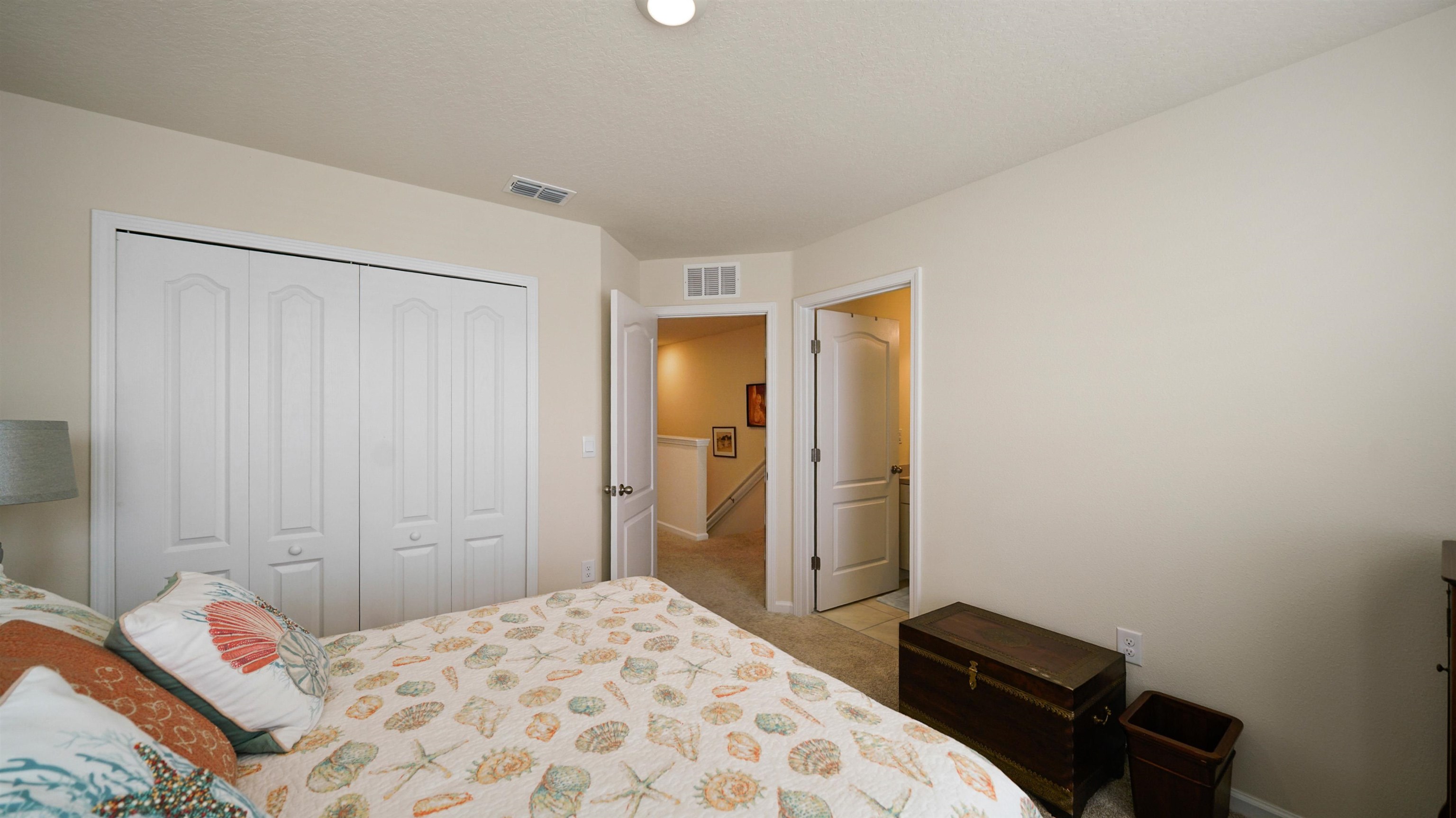 194 Redbud Road Palm Coast, FL 32137 - Photo 19 of 34 a bedroom with a bed and a closet