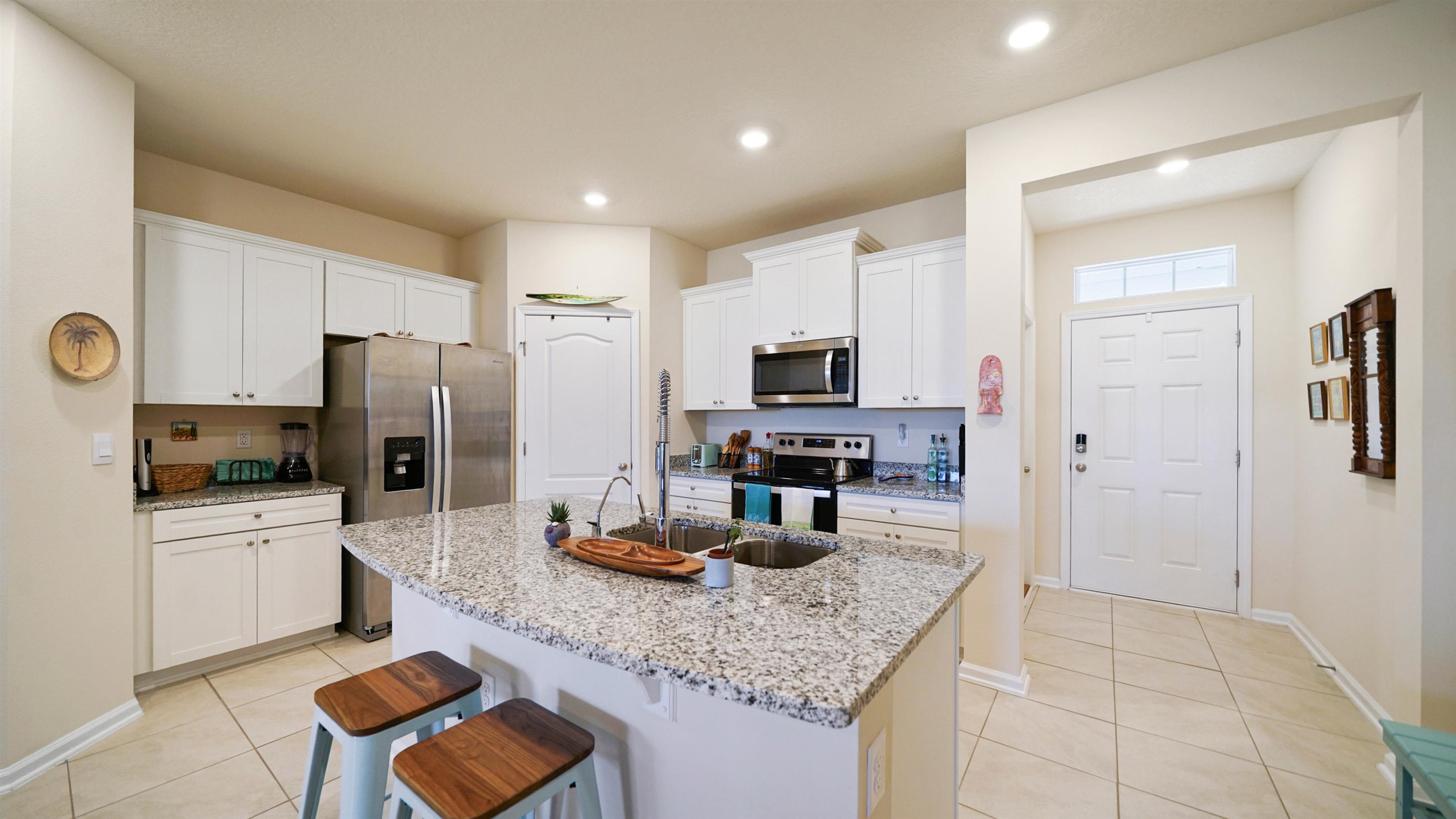 194 Redbud Road Palm Coast, FL 32137 - Photo 2 of 34 a kitchen with stainless steel appliances granite countertop a sink refrigerator and microwave