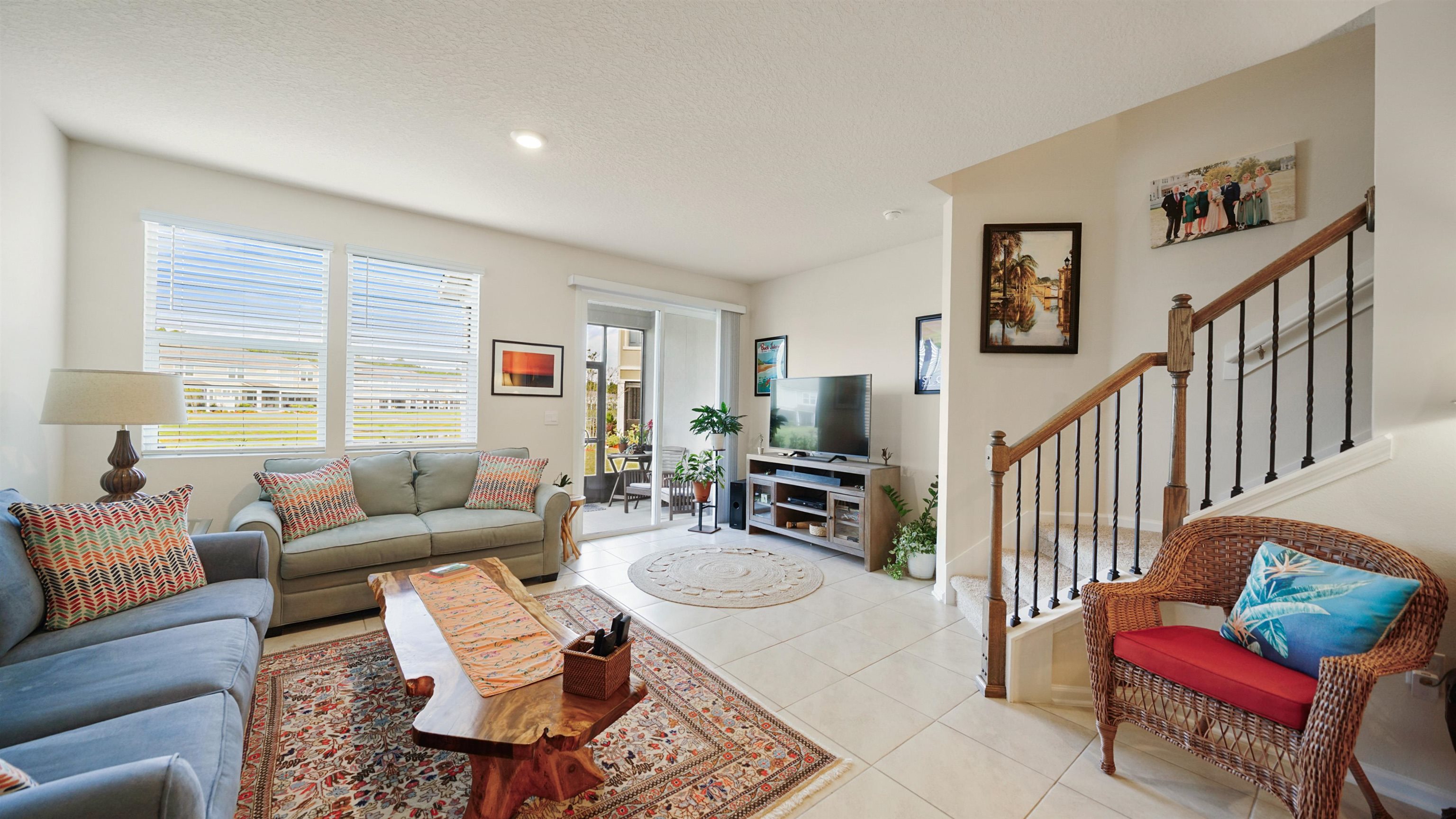 194 Redbud Road Palm Coast, FL 32137 - Photo 3 of 34 a living room with furniture and a wooden floor