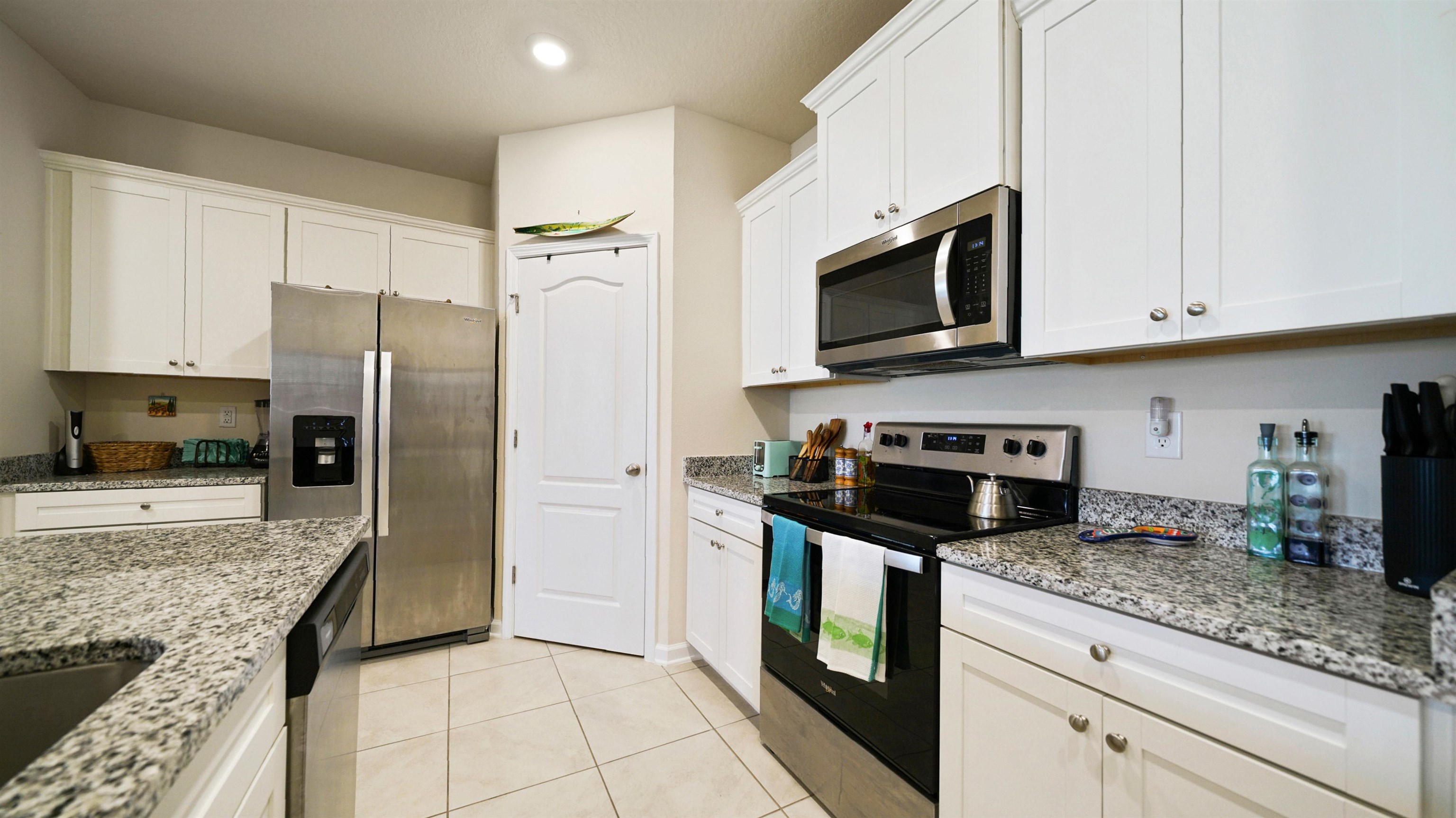 194 Redbud Road Palm Coast, FL 32137 - Photo 4 of 34 a kitchen with stainless steel appliances granite countertop a stove a refrigerator and a sink