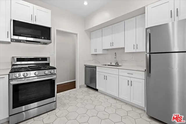 a kitchen with a sink stove and refrigerator