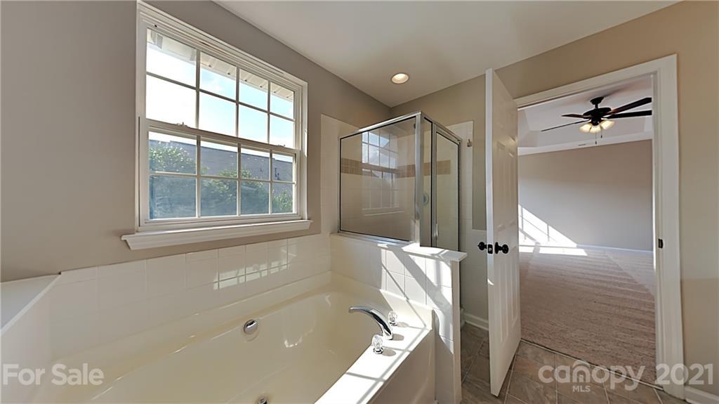 180 Snead Road Fort Mill, SC 29715 - Photo 11 of 15 a bathroom with a bathtub and a shower