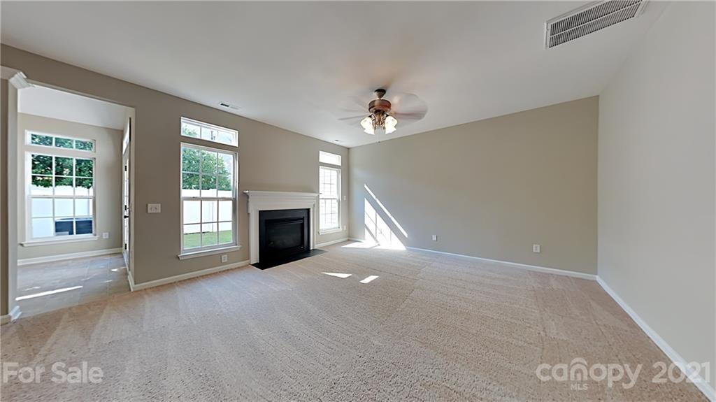 180 Snead Road Fort Mill, SC 29715 - Photo 3 of 15 a view of a livingroom with a fireplace and window