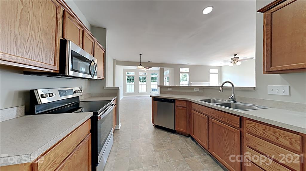 180 Snead Road Fort Mill, SC 29715 - Photo 5 of 15 a kitchen with stainless steel appliances granite countertop a sink stove and cabinets