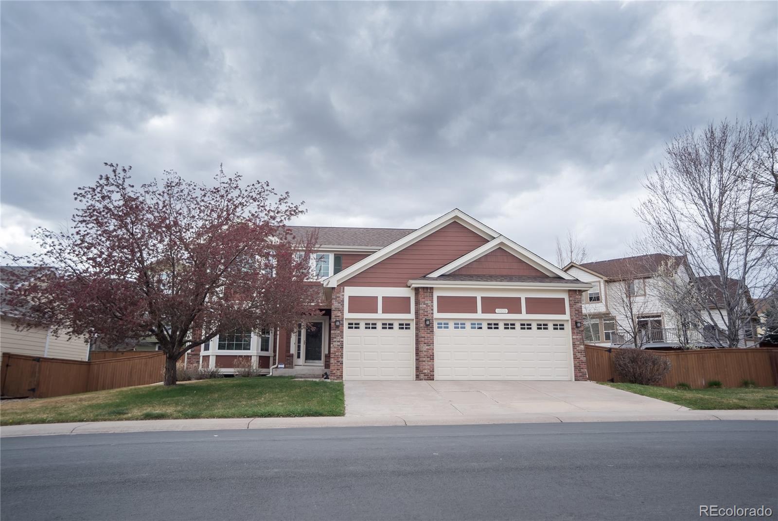 a view of house with a garden and pathway