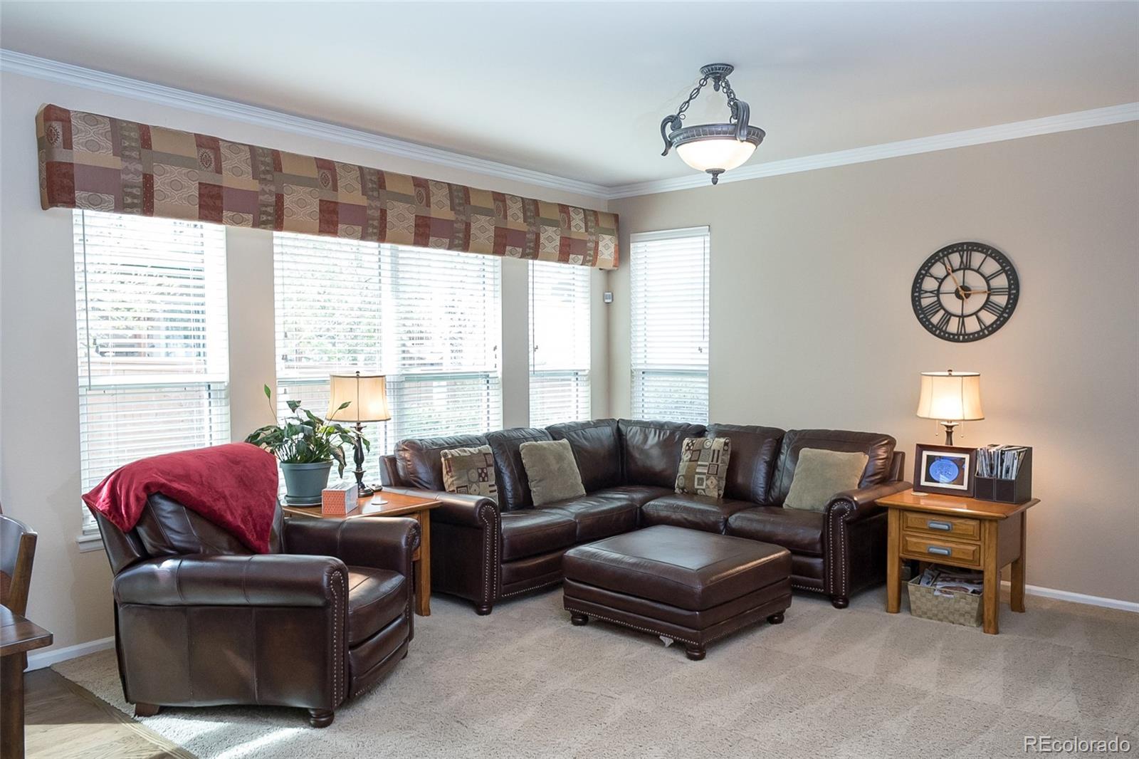 10221 South Nickolas Avenue Highlands Ranch, CO 80130 - Photo 12 of 35 a living room with furniture and a large window
