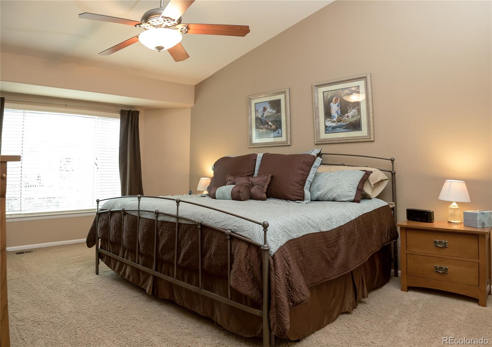 10221 South Nickolas Avenue Highlands Ranch, CO 80130 - Photo 16 of 35 a bedroom with a bed and a chandelier