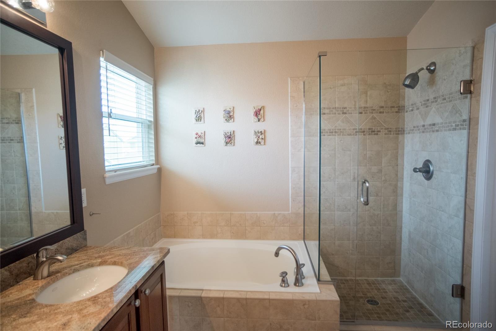 10221 South Nickolas Avenue Highlands Ranch, CO 80130 - Photo 18 of 35 a bathroom with a granite countertop bathtub shower sink and mirror