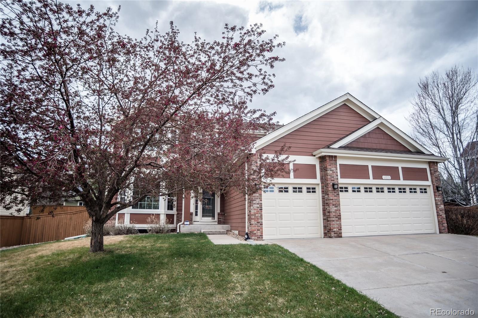 10221 South Nickolas Avenue Highlands Ranch, CO 80130 - Photo 2 of 35 front view of a house with a yard