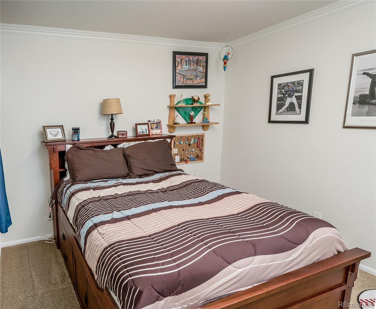 10221 South Nickolas Avenue Highlands Ranch, CO 80130 - Photo 22 of 35 a bedroom with bed and painting on the wall