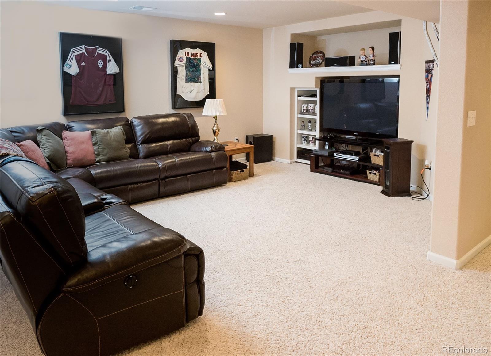 10221 South Nickolas Avenue Highlands Ranch, CO 80130 - Photo 28 of 35 a living room with furniture and a flat screen tv