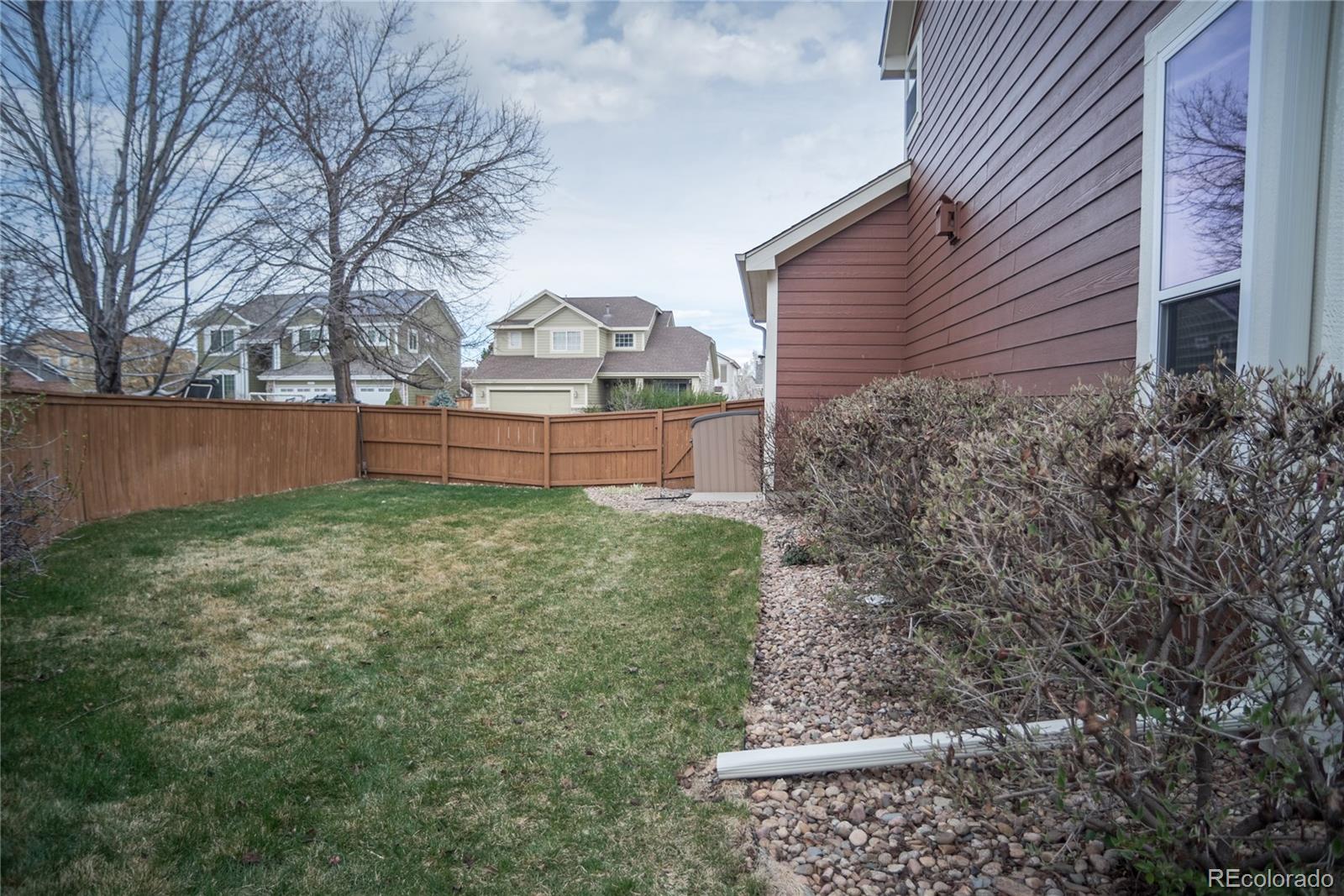 10221 South Nickolas Avenue Highlands Ranch, CO 80130 - Photo 34 of 35 a front view of a house with a yard