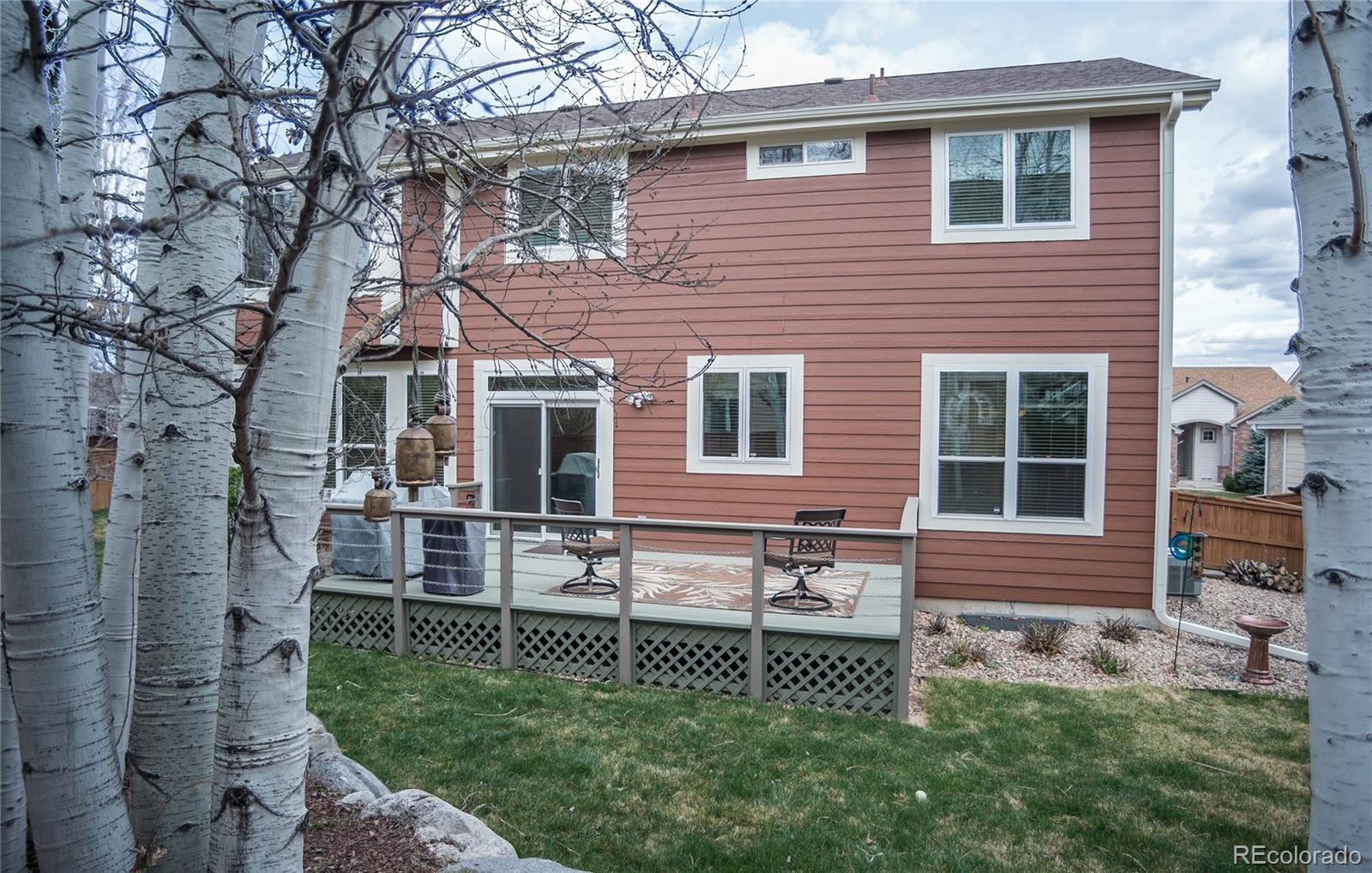 10221 South Nickolas Avenue Highlands Ranch, CO 80130 - Photo 35 of 35 a front view of a house with a garden