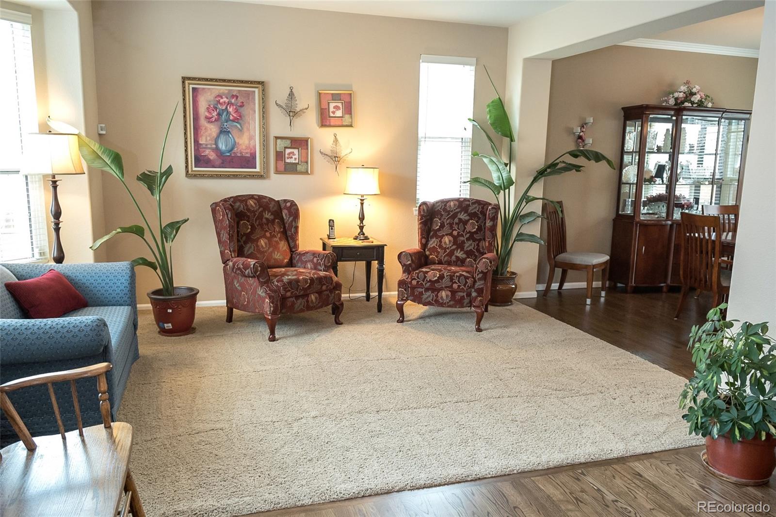 10221 South Nickolas Avenue Highlands Ranch, CO 80130 - Photo 4 of 35 a living room with furniture and a potted plant