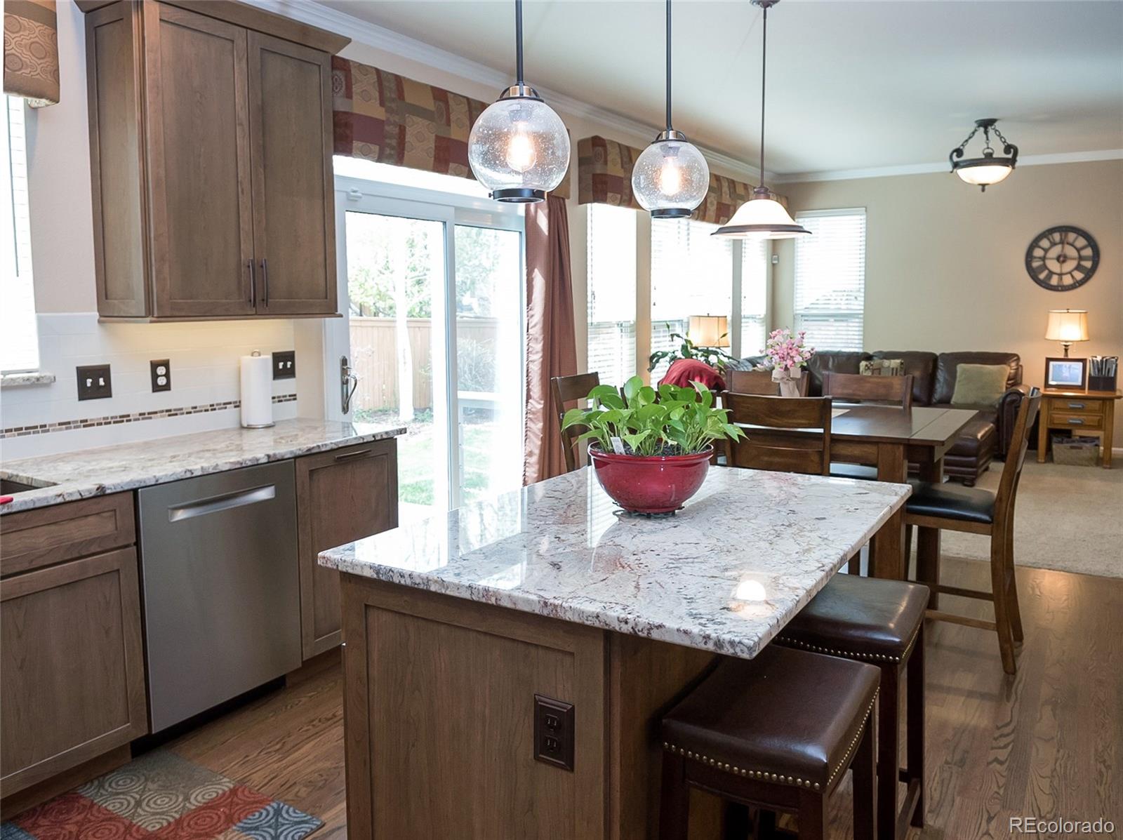 10221 South Nickolas Avenue Highlands Ranch, CO 80130 - Photo 9 of 35 a kitchen with a table and chairs in it