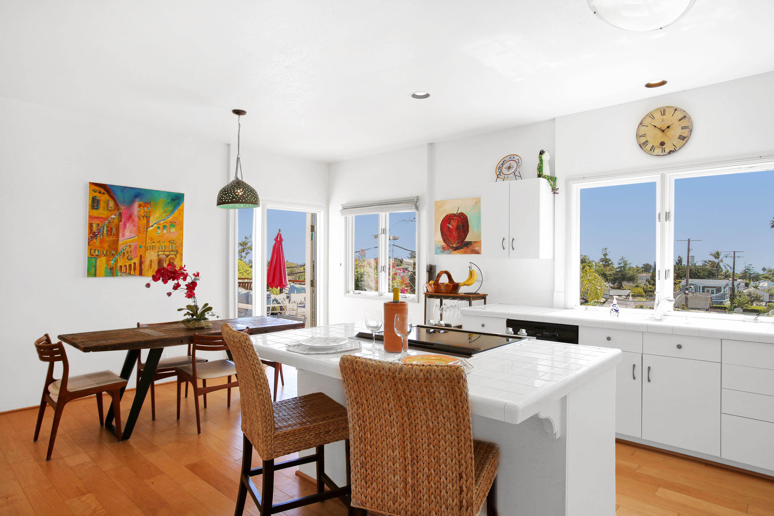 435 Fellowship Road Santa Barbara, CA 93109 - Photo 13 of 47 a view of a dining room and livingroom with furniture wooden floor a rug a painting and a chandelier