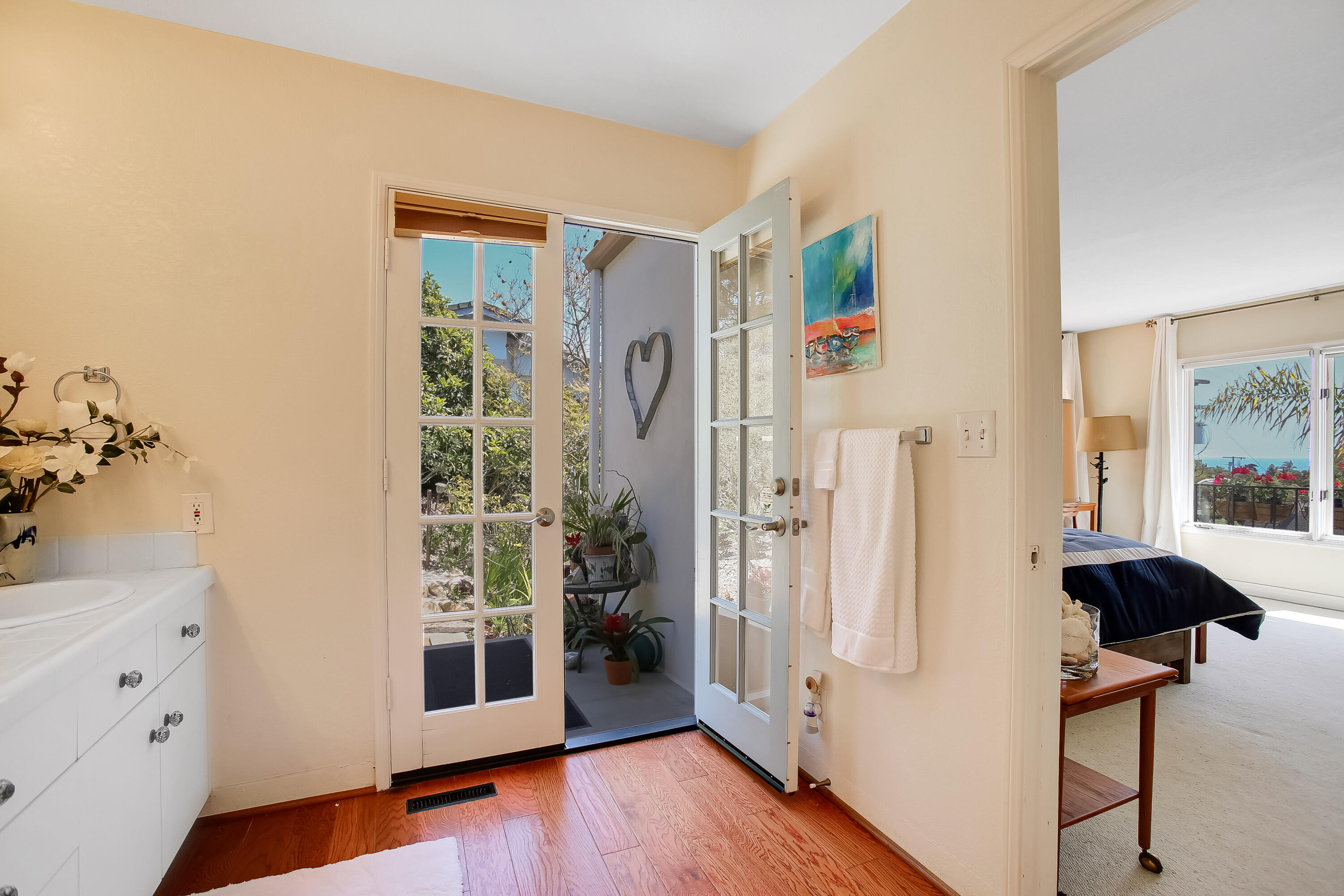 435 Fellowship Road Santa Barbara, CA 93109 - Photo 35 of 47 a view of a bedroom with wooden floor and windows
