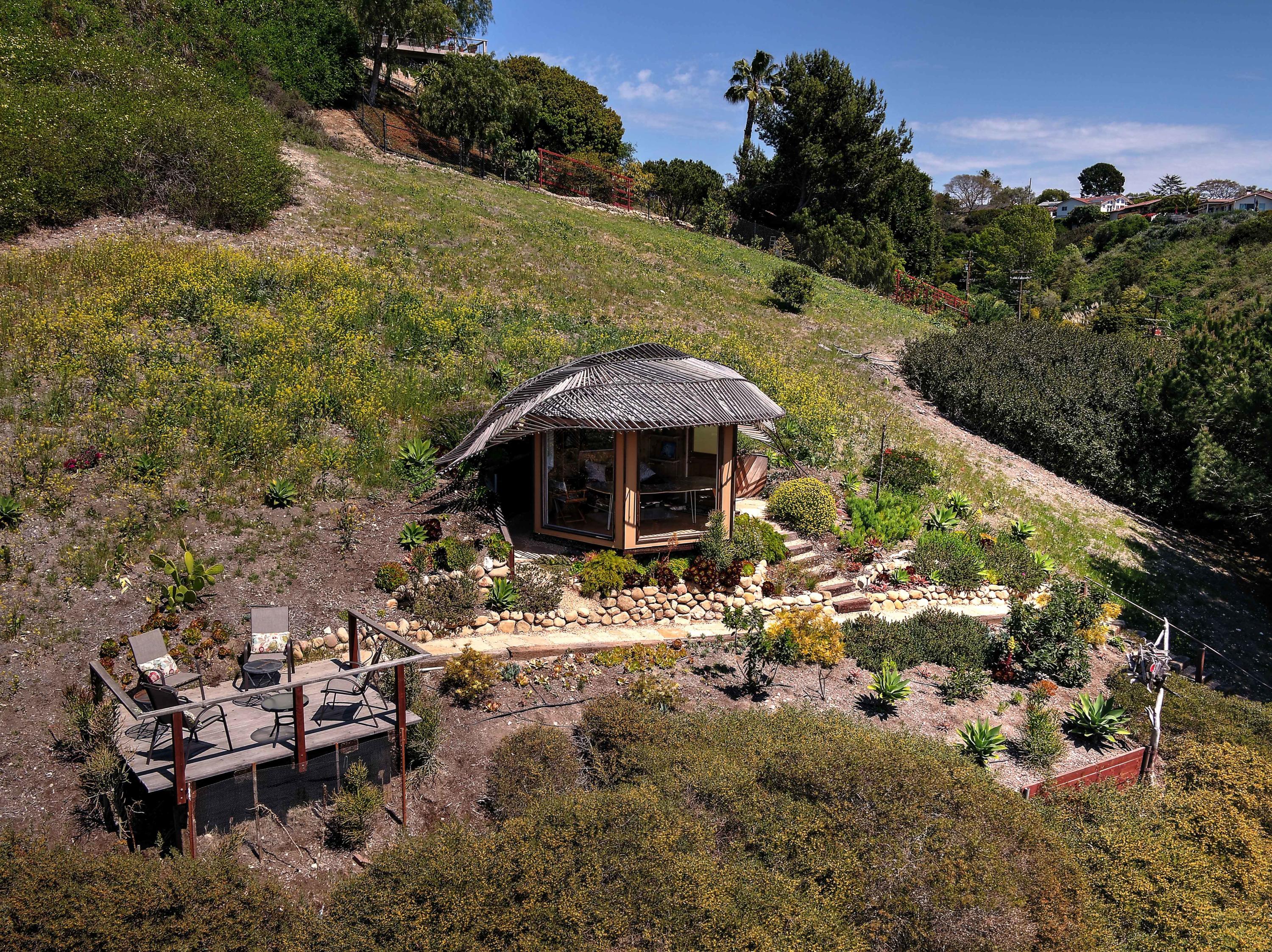 435 Fellowship Road Santa Barbara, CA 93109 - Photo 6 of 47 a backyard of a house with table and chairs under an umbrella