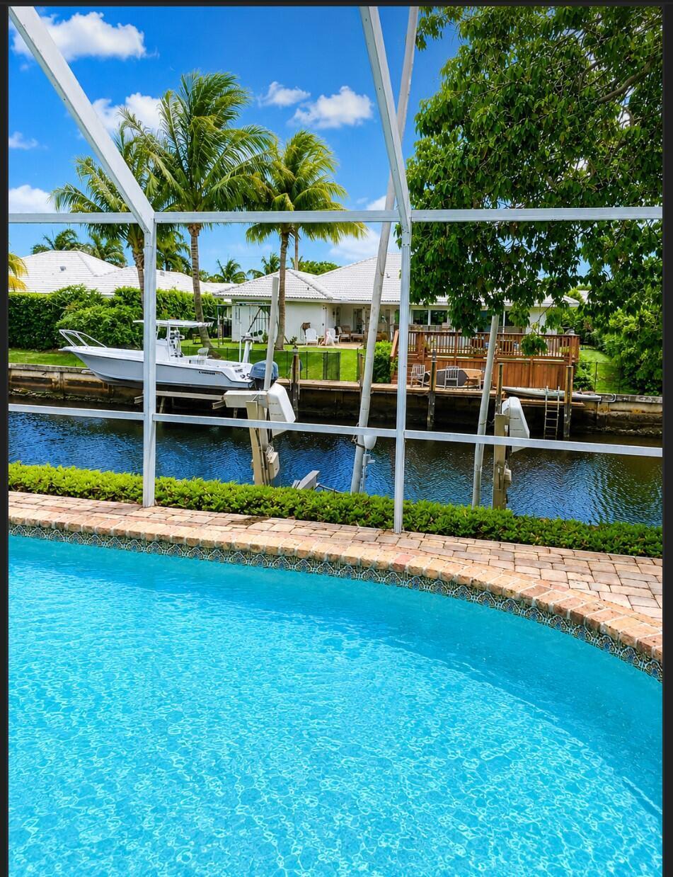 1111 Pepperridge Terrace Boca Raton, FL 33486 - Photo 8 of 8 a view of a chair and tables in the patio next to a yard